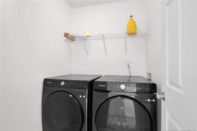 washroom featuring laundry area and washing machine and clothes dryer