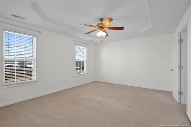 unfurnished room with ceiling fan, baseboards, visible vents, and a raised ceiling