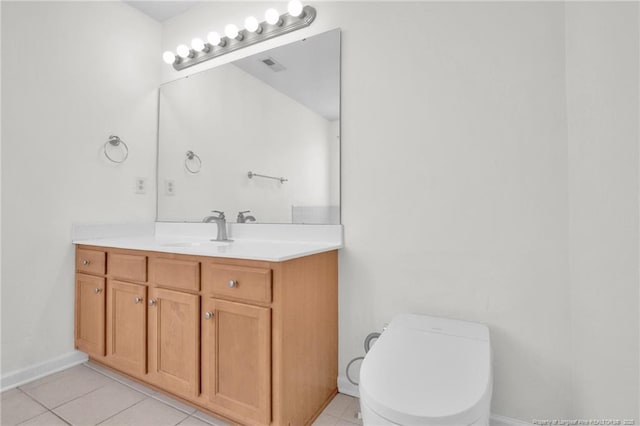 bathroom featuring toilet, visible vents, baseboards, vanity, and tile patterned floors