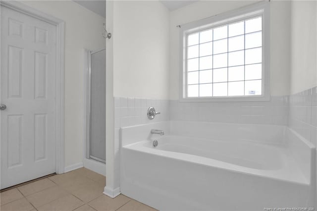 full bath with a garden tub, a stall shower, and tile patterned floors