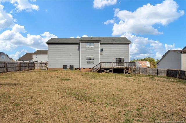 back of house featuring crawl space, a yard, a fenced backyard, and a wooden deck