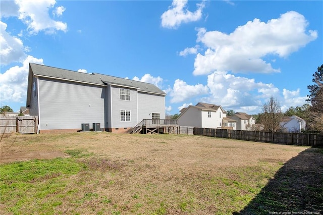 back of house with a lawn, central AC unit, crawl space, a fenced backyard, and a wooden deck