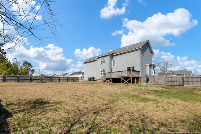 back of property featuring a yard, a fenced backyard, and a wooden deck