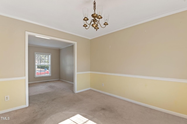 empty room with a chandelier, crown molding, carpet floors, and baseboards