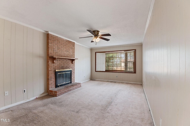 unfurnished living room featuring carpet, a fireplace, and crown molding