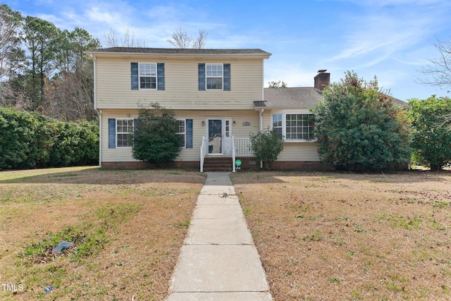 colonial house with a front yard, crawl space, and a chimney