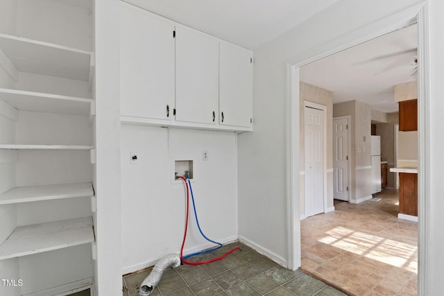 washroom with cabinet space, hookup for a washing machine, electric dryer hookup, and baseboards