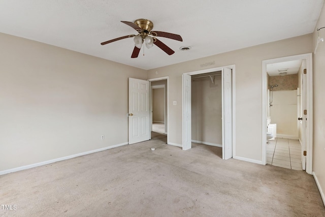 unfurnished bedroom with a closet, visible vents, carpet flooring, ensuite bath, and baseboards