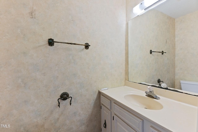 bathroom featuring toilet and vanity