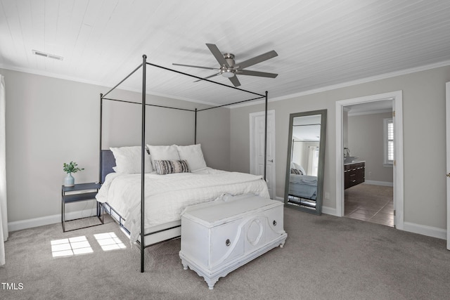 carpeted bedroom with ceiling fan, baseboards, and ornamental molding