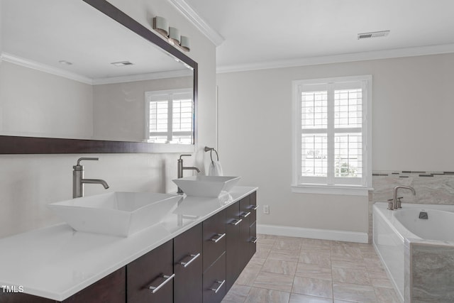 full bath featuring a sink, visible vents, baseboards, and crown molding