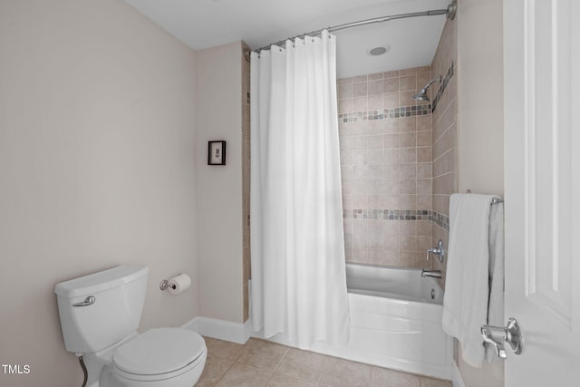 full bath with tile patterned flooring, shower / bath combination with curtain, toilet, and baseboards