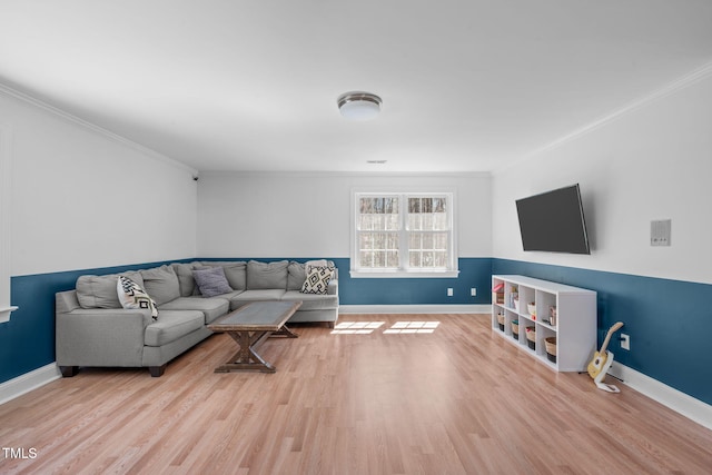 living room featuring baseboards, wood finished floors, and crown molding