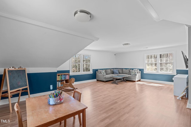 interior space featuring plenty of natural light, baseboards, and wood finished floors