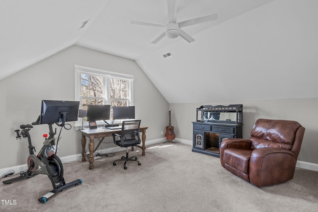 carpeted office space featuring vaulted ceiling, visible vents, baseboards, and ceiling fan