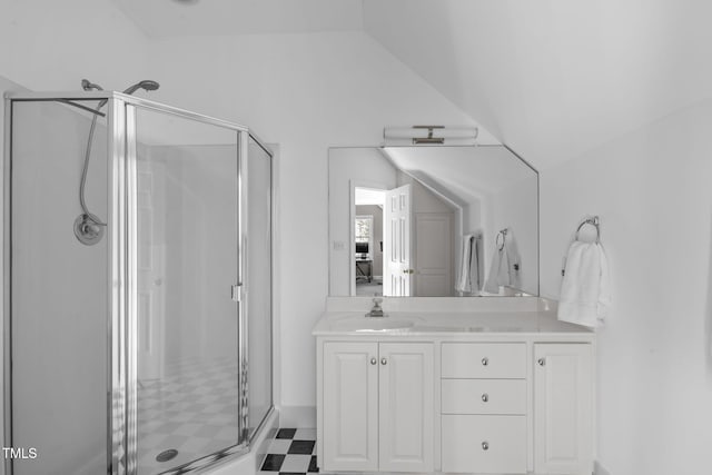 bathroom with tile patterned floors, lofted ceiling, a stall shower, and vanity