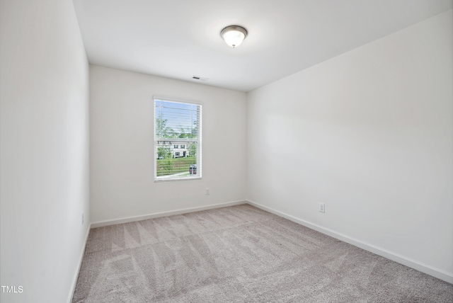 empty room with carpet floors and baseboards