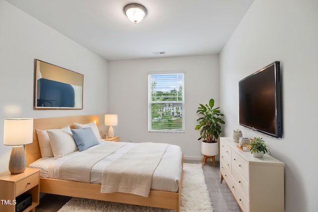 bedroom with baseboards and carpet
