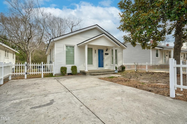 bungalow-style house with a porch and fence