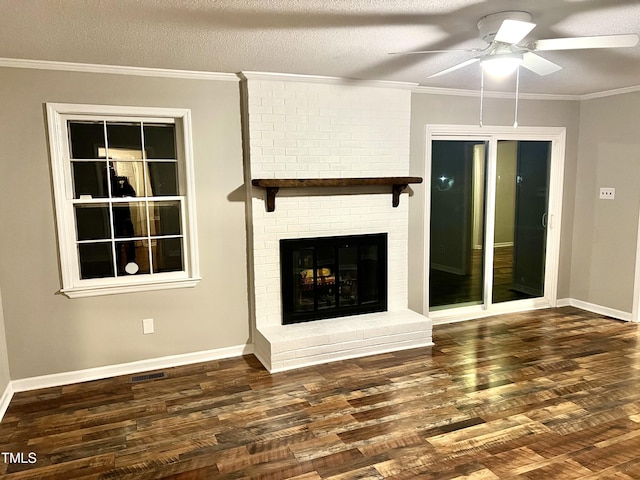 unfurnished living room featuring visible vents, a textured ceiling, wood finished floors, and crown molding