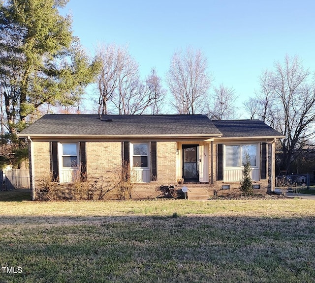 ranch-style house with crawl space, brick siding, fence, and a front lawn