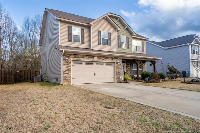 view of front of property featuring central air condition unit, fence, stone siding, concrete driveway, and a front lawn