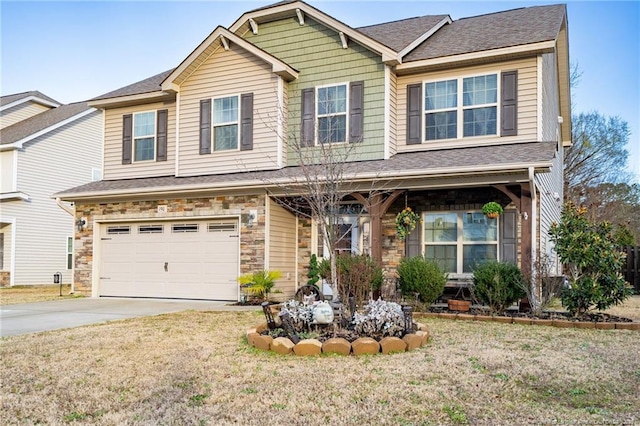 craftsman house with a front yard, stone siding, driveway, and an attached garage