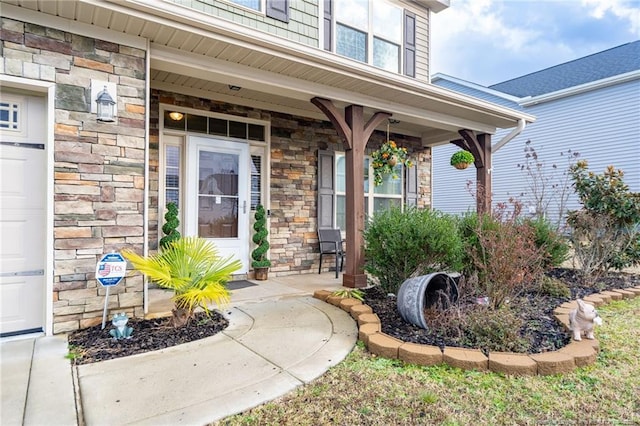 entrance to property featuring stone siding and a porch