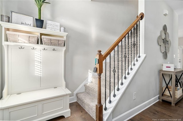 mudroom with wood finished floors and baseboards