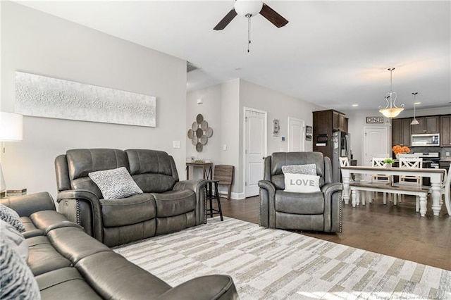 living area featuring dark wood-style floors, ceiling fan, and recessed lighting