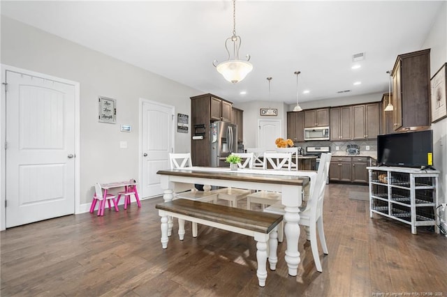 dining space with dark wood-style floors, visible vents, and recessed lighting