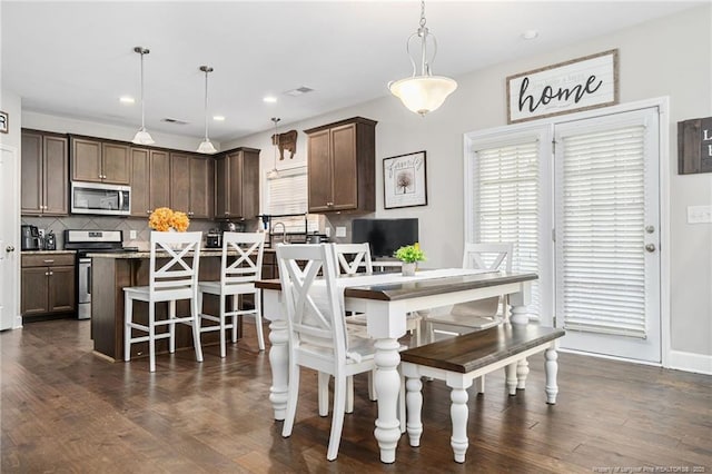 dining area featuring visible vents, dark wood-type flooring, and recessed lighting