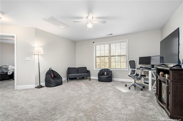 home office featuring carpet floors, a ceiling fan, visible vents, and baseboards