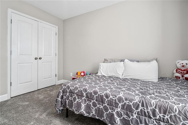 bedroom with carpet floors, a closet, and baseboards