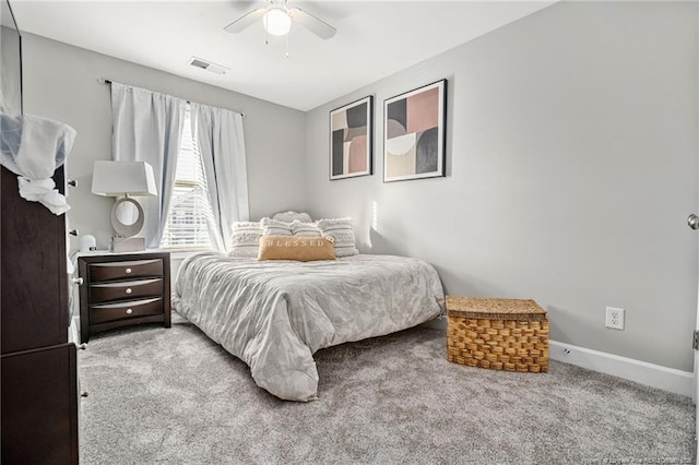 carpeted bedroom with ceiling fan, visible vents, and baseboards