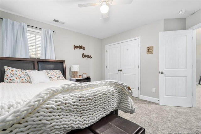 carpeted bedroom with a closet, visible vents, ceiling fan, and baseboards