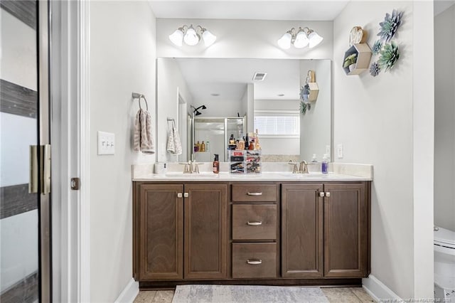 full bathroom with double vanity, visible vents, toilet, a sink, and a shower stall