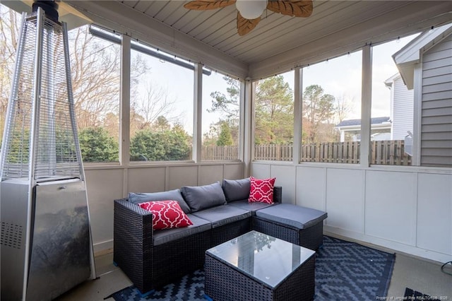 sunroom / solarium with a healthy amount of sunlight and a ceiling fan