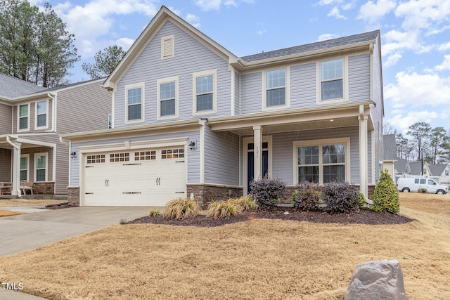 view of front of property with an attached garage, stone siding, and driveway