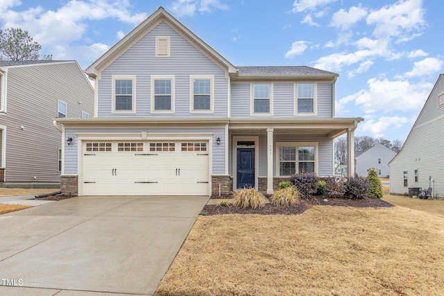 view of front of home featuring a porch, stone siding, an attached garage, and concrete driveway