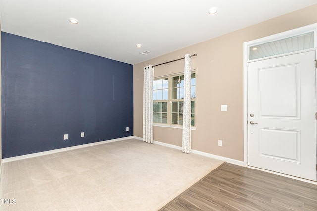 unfurnished room featuring recessed lighting, visible vents, baseboards, and wood finished floors