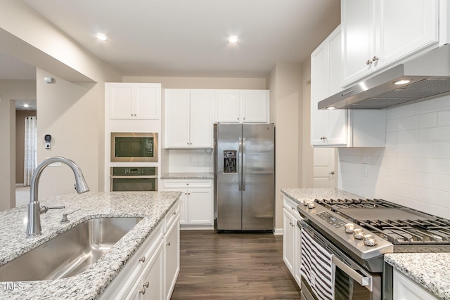 kitchen featuring under cabinet range hood, a sink, white cabinetry, stainless steel appliances, and dark wood-style flooring