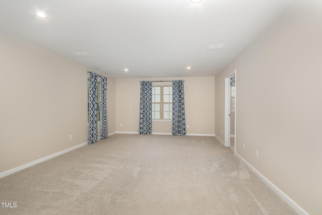 unfurnished room with recessed lighting, visible vents, baseboards, and light colored carpet