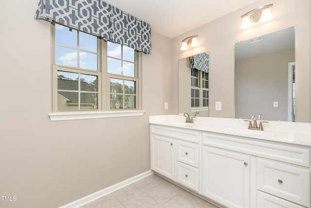 bathroom with tile patterned floors, visible vents, baseboards, and a sink