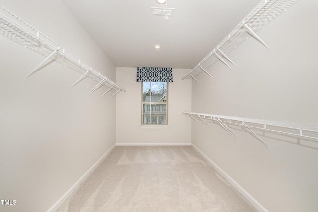 walk in closet featuring visible vents and light colored carpet