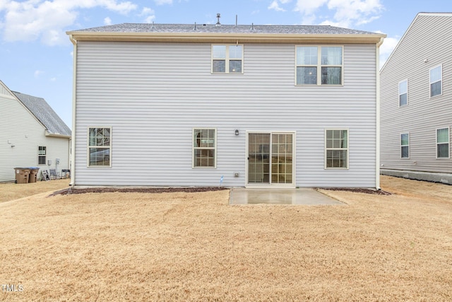 rear view of house featuring a yard and a patio