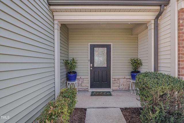 entrance to property featuring stone siding