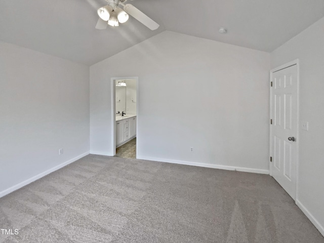 unfurnished bedroom with carpet, lofted ceiling, a ceiling fan, ensuite bath, and baseboards