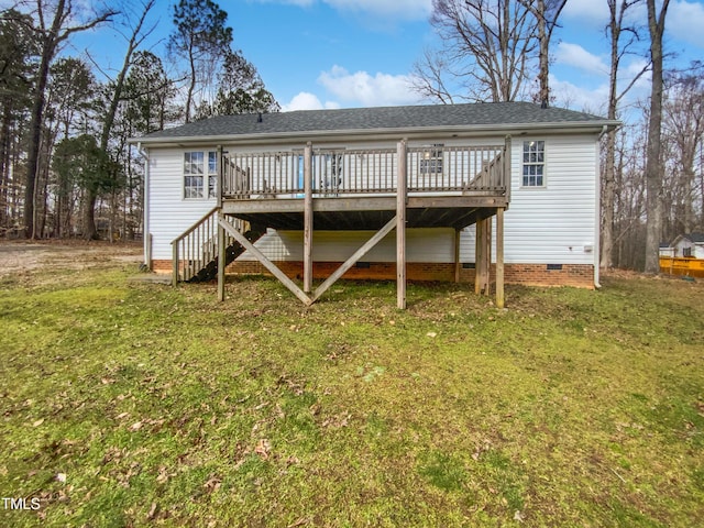 rear view of property featuring crawl space, stairs, a lawn, and a wooden deck