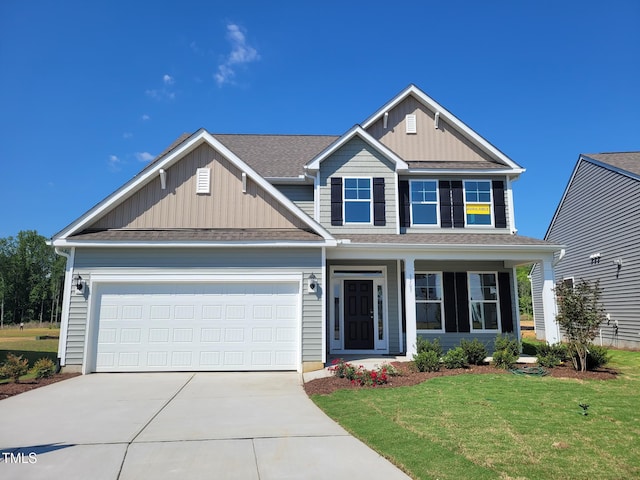 3703 Cessna Way Unit 9, Wilson, NC 27896 - view of front of property featuring concrete driveway, board and batten siding, a front lawn, and a garage